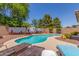 Beautiful backyard pool with lounge chairs, desert landscaping, and a mural on the privacy fence at 1142 E Mayfield Dr, San Tan Valley, AZ 85143