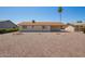 View of the home's backyard with gravel, desert landscaping and a covered patio at 11627 S Iroquois Dr, Phoenix, AZ 85044