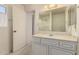 Classic bathroom featuring a vanity with storage, a large mirror, and a shower at 11627 S Iroquois Dr, Phoenix, AZ 85044