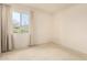 Bright bedroom featuring neutral carpet, light walls and a window overlooking the neighborhood at 11627 S Iroquois Dr, Phoenix, AZ 85044