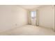 Bright bedroom with neutral carpet, light walls and a window overlooking the neighborhood at 11627 S Iroquois Dr, Phoenix, AZ 85044