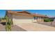 Single-story home with a spacious driveway, desert landscaping, and neutral-toned exterior on a clear day at 11627 S Iroquois Dr, Phoenix, AZ 85044