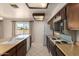 Spacious kitchen with a peninsula, featuring neutral countertops and tile flooring at 11627 S Iroquois Dr, Phoenix, AZ 85044