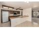 Traditional kitchen featuring wood cabinetry, white appliances, and a tiled floor at 11627 S Iroquois Dr, Phoenix, AZ 85044