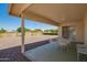 Covered patio with furniture overlooking a gravel backyard and desert landscaping at 11627 S Iroquois Dr, Phoenix, AZ 85044