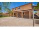Expansive backyard featuring a covered patio, lush landscaping, and a beautiful view of the home's exterior at 12029 W Overlin Ln, Avondale, AZ 85323