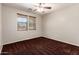 Bedroom with windows and a ceiling fan at 12029 W Overlin Ln, Avondale, AZ 85323