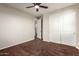 A bedroom has neutral walls, a ceiling fan, soft carpet, and a closet with sliding doors at 12029 W Overlin Ln, Avondale, AZ 85323