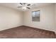 The bedroom features soft carpet, a window with blinds, and neutral-colored walls at 12029 W Overlin Ln, Avondale, AZ 85323