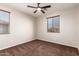 The bedroom is bright and airy, with a ceiling fan, plush carpet, and a window at 12029 W Overlin Ln, Avondale, AZ 85323