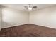 Spacious bedroom with a ceiling fan and neutral carpet at 12029 W Overlin Ln, Avondale, AZ 85323
