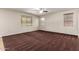 Comfortable bedroom with neutral walls, three bright windows, plush carpeting, and plenty of natural light at 12029 W Overlin Ln, Avondale, AZ 85323
