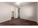 This carpeted bedroom features neutral walls, a lighted ceiling fan and a closet at 12029 W Overlin Ln, Avondale, AZ 85323