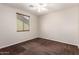 The bedroom is bright and airy, with a ceiling fan, plush carpet, and a window at 12029 W Overlin Ln, Avondale, AZ 85323