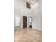 Inviting entryway boasts tile floors, high ceilings, and a striking front door, creating a grand entrance at 12029 W Overlin Ln, Avondale, AZ 85323