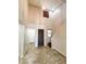 Inviting entryway with high ceilings, tile flooring, and a modern light fixture at 12029 W Overlin Ln, Avondale, AZ 85323