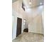 Inviting foyer with a soaring ceiling, a dark wooden door, and a staircase leading to the upper level at 12029 W Overlin Ln, Avondale, AZ 85323