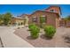 View of the front yard with desert landscaping on a sunny day at 12029 W Overlin Ln, Avondale, AZ 85323