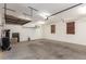 Spacious garage with overhead storage racks and ample room for vehicles and projects at 12029 W Overlin Ln, Avondale, AZ 85323