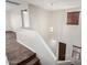 Carpeted stairway with a modern chandelier overhead, leading to the upper level of the home at 12029 W Overlin Ln, Avondale, AZ 85323