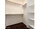 Walk-in closet with built-in shelving and rods at 12029 W Overlin Ln, Avondale, AZ 85323