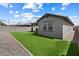 Well-maintained backyard features artificial turf, rock beds, and a covered patio at 15070 W Garfield St, Goodyear, AZ 85338
