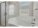 Bathroom with a shower stall, soaking tub and window providing natural light at 15070 W Garfield St, Goodyear, AZ 85338