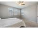Bedroom with neutral walls and carpet, ceiling fan and lots of natural light at 15070 W Garfield St, Goodyear, AZ 85338