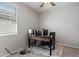 Bedroom with a wooden desk, ceiling fan, neutral walls, and a patterned rug at 15070 W Garfield St, Goodyear, AZ 85338