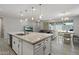 Bright kitchen flows seamlessly into the living area with eat in nook and recessed lighting at 15070 W Garfield St, Goodyear, AZ 85338