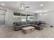 Cozy living room has large windows for natural light with views of the backyard at 15070 W Garfield St, Goodyear, AZ 85338