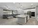 Open-concept living space features a spacious kitchen, dining area, and comfortable seating at 15070 W Garfield St, Goodyear, AZ 85338