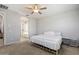 Spacious bedroom with a queen-size bed, ensuite bath and neutral walls and carpet at 15070 W Garfield St, Goodyear, AZ 85338