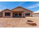 Rear view of the home, showcasing a spacious backyard and patio area at 16147 W Central St, Surprise, AZ 85374