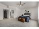 Spacious bedroom featuring neutral tones, an archway, plush carpet, and a cozy seating area at 16147 W Central St, Surprise, AZ 85374