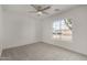 Carpeted bedroom featuring a large window overlooking the neighborhood, offering bright natural light at 16147 W Central St, Surprise, AZ 85374
