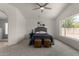 Bright bedroom with ceiling fan and a large window providing views of the backyard at 16147 W Central St, Surprise, AZ 85374