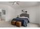 Well-lit bedroom with plush carpet, fan, and tufted headboard provides a cozy and stylish retreat at 16147 W Central St, Surprise, AZ 85374