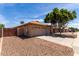 View of the home's side, including a two-car garage and desert landscaping at 16147 W Central St, Surprise, AZ 85374
