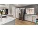 Kitchen featuring stainless steel refrigerator, white cabinets and modern tile backsplash at 16147 W Central St, Surprise, AZ 85374