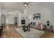 Inviting living room featuring fireplace, wood floors, modern decor, and comfortable seating at 16147 W Central St, Surprise, AZ 85374