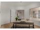 Bright home office with wood floors, desk, and open doorway to living spaces at 16147 W Central St, Surprise, AZ 85374
