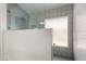Stylish shower with decorative tile, glass door, and a small window at 16147 W Central St, Surprise, AZ 85374