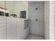 Sleek shower with gray tiling, mosaic tile accents, and a built-in shelf at 16147 W Central St, Surprise, AZ 85374