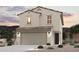 Charming two-story home with a tile roof, neutral stucco exterior, and a spacious two-car garage at 17380 W Jessie Ln, Surprise, AZ 85387