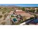 Backyard view of desert home featuring a sparkling pool and a covered patio at 17562 W Desert Sage Dr, Goodyear, AZ 85338