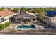 A charming backyard with a kidney-shaped pool, covered patio, desert landscaping and privacy fence at 17562 W Desert Sage Dr, Goodyear, AZ 85338