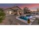 Inviting backyard featuring a refreshing pool, covered patio, and low-maintenance desert landscaping at 17562 W Desert Sage Dr, Goodyear, AZ 85338