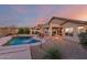 Entertainer's backyard featuring a pool, covered patio and desert landscape with mountain views at 17562 W Desert Sage Dr, Goodyear, AZ 85338