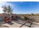 Serene backyard retreat with comfortable lounge chairs, desert landscaping, and a view of the surrounding hills at 17562 W Desert Sage Dr, Goodyear, AZ 85338